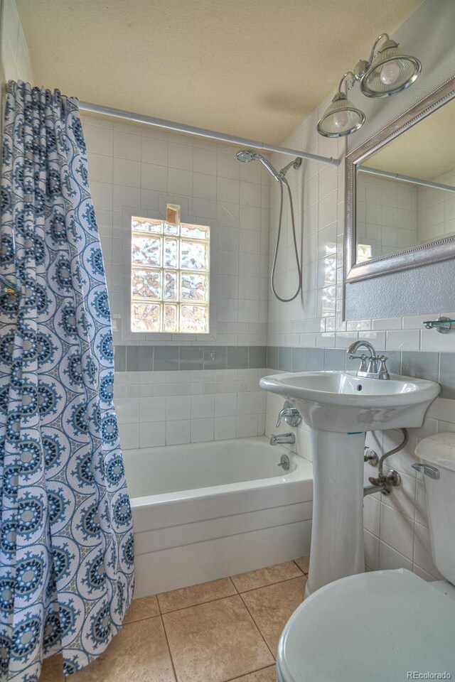 11 Hupp Rd, Bailey, CO 80421 - bathroom featuring tile walls, decorative backsplash, toilet, tile patterned floors, and shower / bath combo with shower curtain