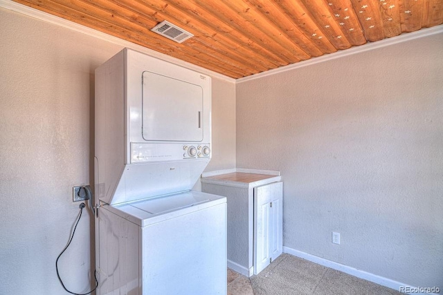 11 Hupp Rd, Bailey, CO 80421 - washroom with visible vents, baseboards, stacked washer and dryer, cabinet space, and wood ceiling
