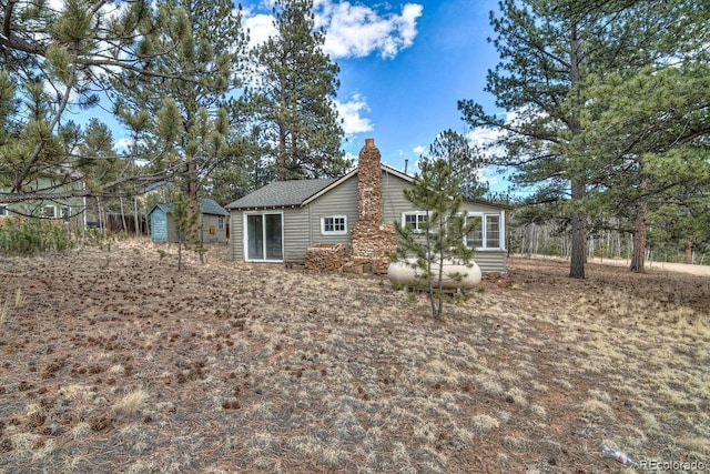 11 Hupp Rd, Bailey, CO 80421 - rear view of house with a chimney and an outdoor structure