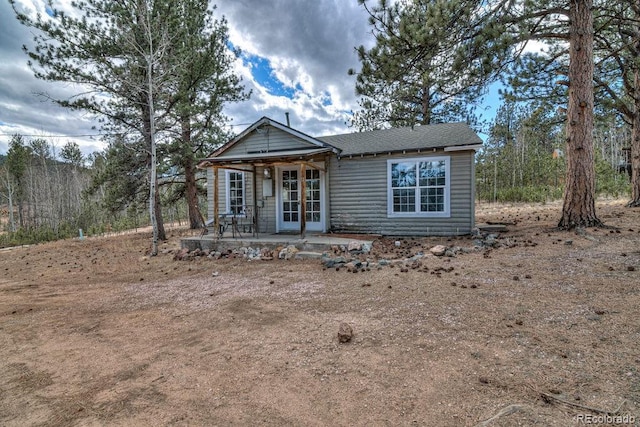 11 Hupp Rd, Bailey, CO 80421 - view of front of home with a patio area, french doors, and roof with shingles