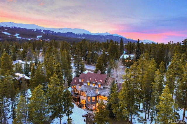 aerial view at dusk featuring a mountain view