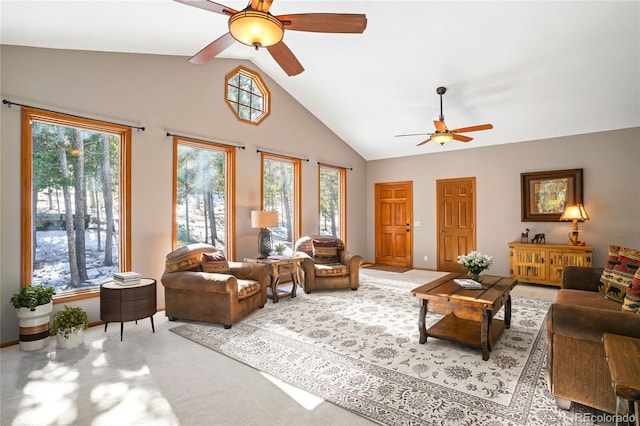 living area featuring ceiling fan, high vaulted ceiling, and light colored carpet