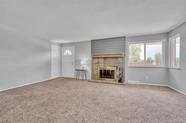 3463 W Bowles Ave, Littleton, CO 80123 - unfurnished living room featuring healthy amount of natural light, a textured ceiling, carpet, and a fireplace