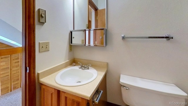 bathroom featuring toilet and vanity