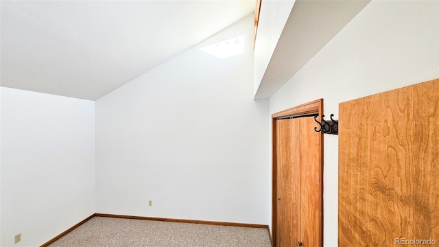 bonus room featuring vaulted ceiling and carpet flooring