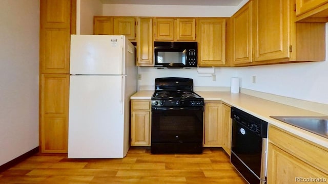 kitchen featuring light hardwood / wood-style flooring and black appliances