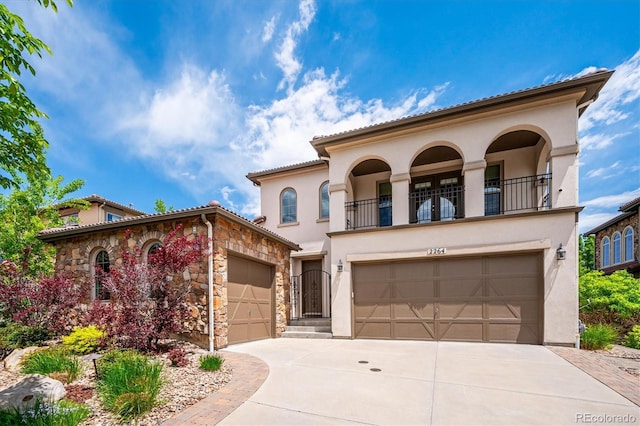 2264 S Joyce St, Lakewood, CO 80228 - mediterranean / spanish house with stucco siding, a balcony, and concrete driveway