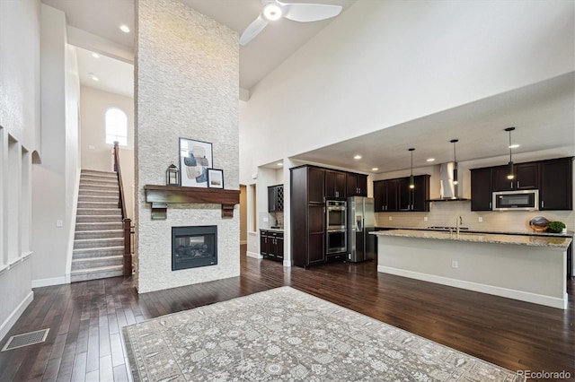 2264 S Joyce St, Lakewood, CO 80228 - living area with a high ceiling, dark wood-style floors, stairway, ceiling fan, and baseboards