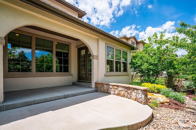 2264 S Joyce St, Lakewood, CO 80228 - entrance to property with stucco siding, fence, and a patio