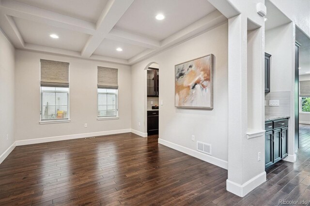 2264 S Joyce St, Lakewood, CO 80228 - unfurnished room featuring dark wood finished floors, recessed lighting, beam ceiling, coffered ceiling, and arched walkways
