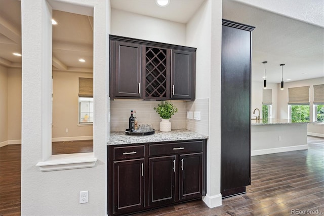2264 S Joyce St, Lakewood, CO 80228 - indoor dry bar with dark wood-type flooring, tasteful backsplash, and baseboards