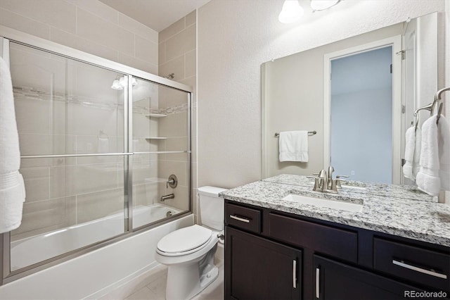 2264 S Joyce St, Lakewood, CO 80228 - full bathroom featuring vanity, toilet, and combined bath / shower with glass door