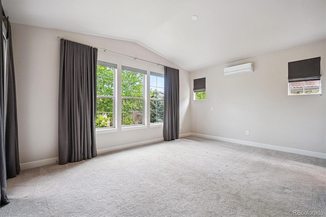 2264 S Joyce St, Lakewood, CO 80228 - carpeted empty room with a wall unit AC, vaulted ceiling, and baseboards