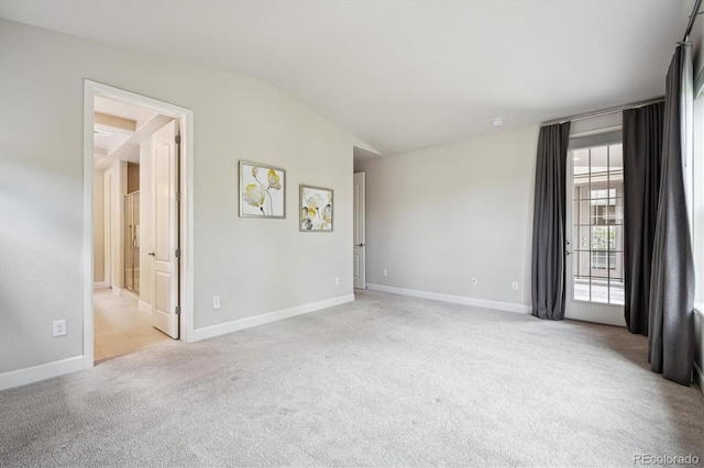 2264 S Joyce St, Lakewood, CO 80228 - carpeted empty room featuring lofted ceiling and baseboards