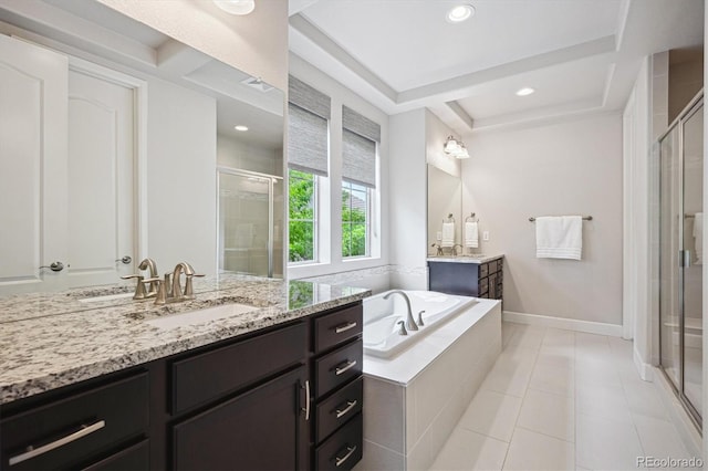 2264 S Joyce St, Lakewood, CO 80228 - full bath with a shower stall, a bath, two vanities, tile patterned flooring, and recessed lighting