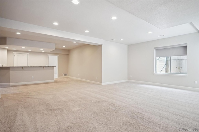 2264 S Joyce St, Lakewood, CO 80228 - unfurnished living room featuring light carpet, recessed lighting, and baseboards