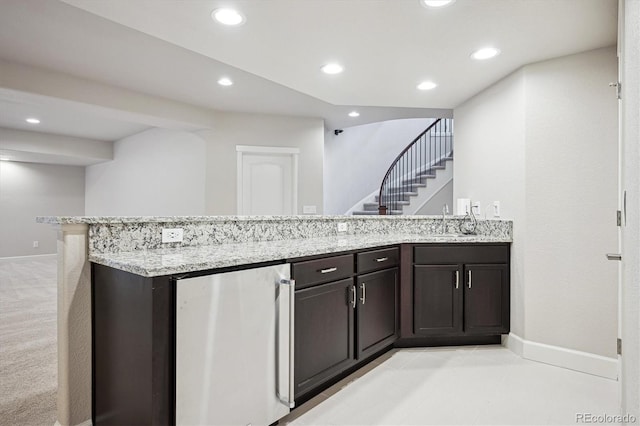 2264 S Joyce St, Lakewood, CO 80228 - kitchen with refrigerator, light stone countertops, a sink, baseboards, and recessed lighting