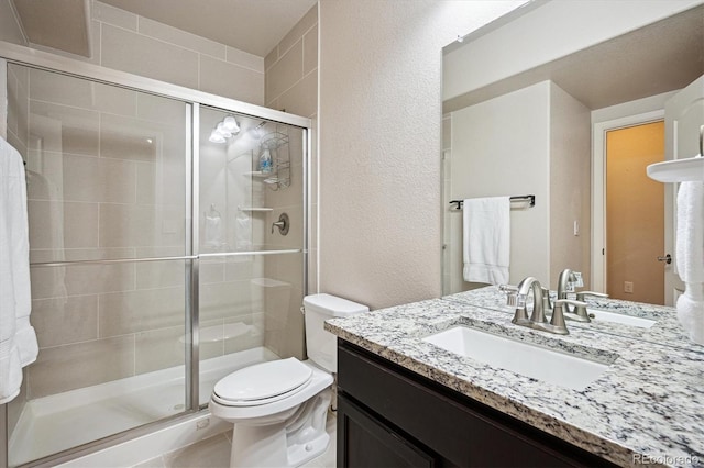2264 S Joyce St, Lakewood, CO 80228 - full bathroom with toilet, a stall shower, vanity, and a textured wall
