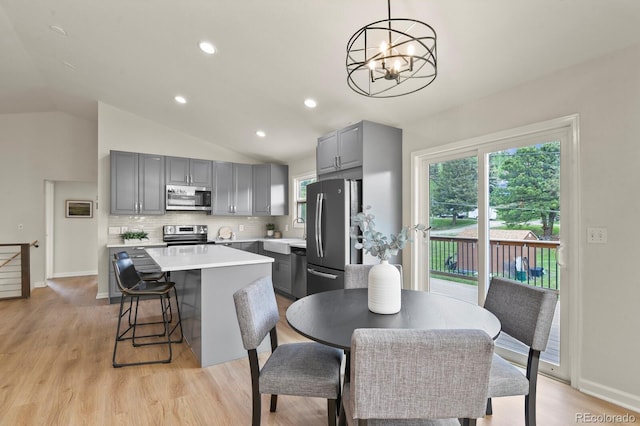 30221 Stagecoach Blvd, Evergreen, CO 80439 - dining space featuring a chandelier, lofted ceiling, light wood-type flooring, recessed lighting, and baseboards