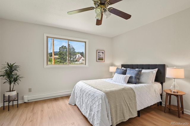 30221 Stagecoach Blvd, Evergreen, CO 80439 - bedroom featuring a baseboard radiator, light wood-style floors, baseboards, and a ceiling fan