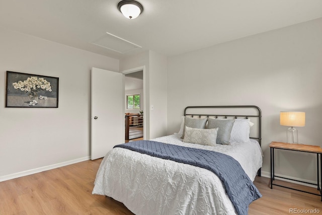 30221 Stagecoach Blvd, Evergreen, CO 80439 - bedroom featuring attic access, wood finished floors, and baseboards