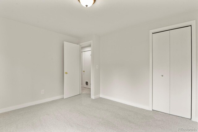 30221 Stagecoach Blvd, Evergreen, CO 80439 - unfurnished bedroom featuring light carpet, baseboards, and a closet