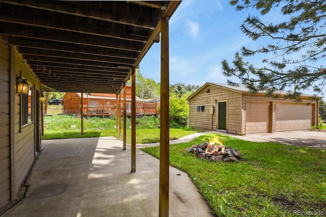 30221 Stagecoach Blvd, Evergreen, CO 80439 - view of patio with a fire pit, a detached garage, and an outbuilding