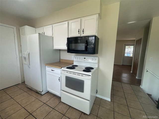 kitchen with white cabinets, white appliances, and dark tile flooring