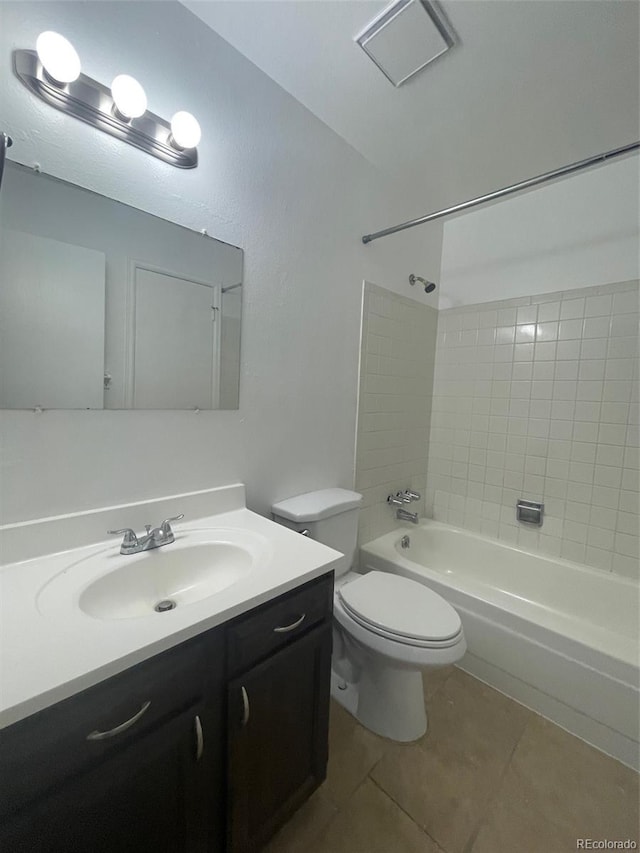 full bathroom with tiled shower / bath combo, vanity, tile floors, and toilet