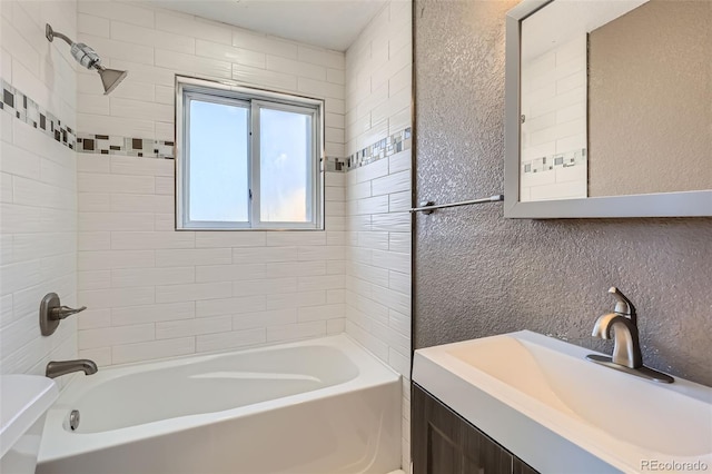 bathroom featuring vanity and tiled shower / bath