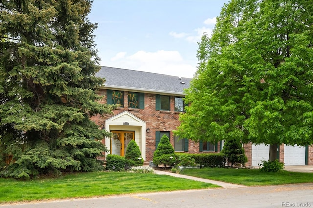 view of front of property featuring brick siding, driveway, a front lawn, and roof with shingles