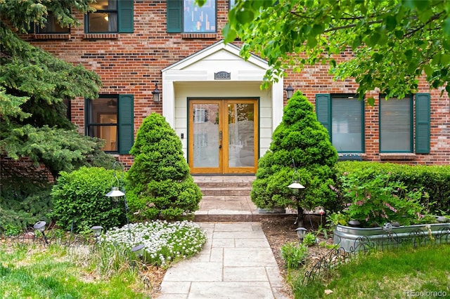 view of exterior entry with french doors and brick siding