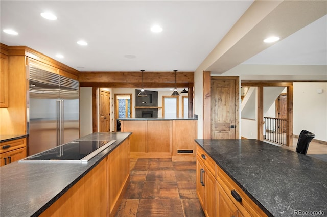 kitchen featuring built in refrigerator, black electric cooktop, recessed lighting, brown cabinetry, and pendant lighting
