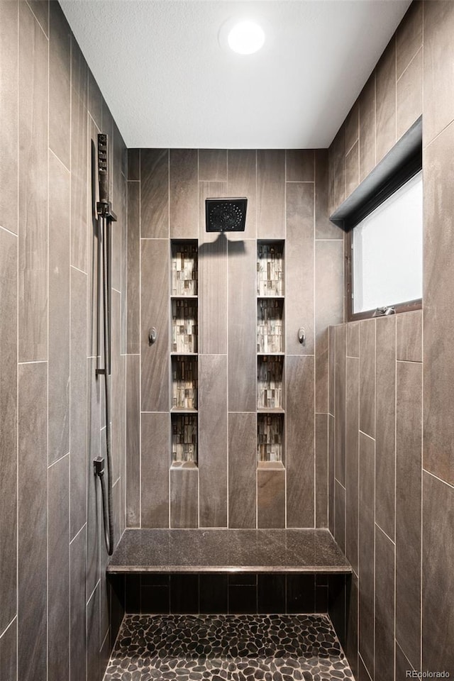 bathroom with tiled shower