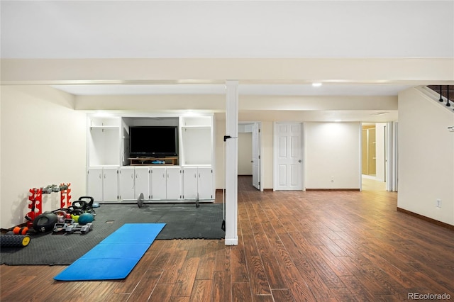 workout area with dark wood finished floors and baseboards