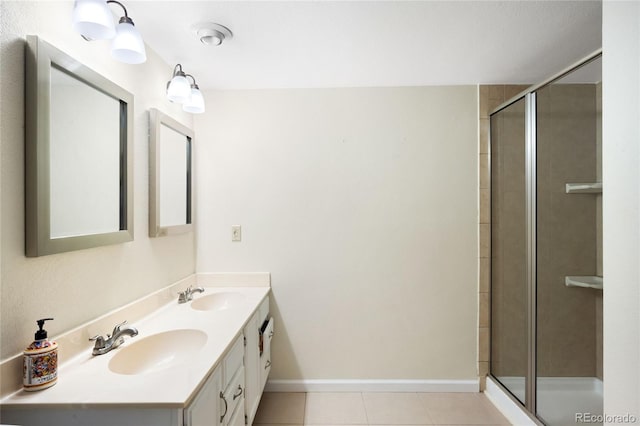full bathroom featuring a shower stall, tile patterned flooring, double vanity, and baseboards