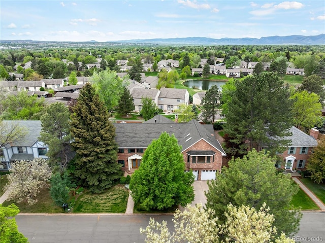 aerial perspective of suburban area featuring a water and mountain view