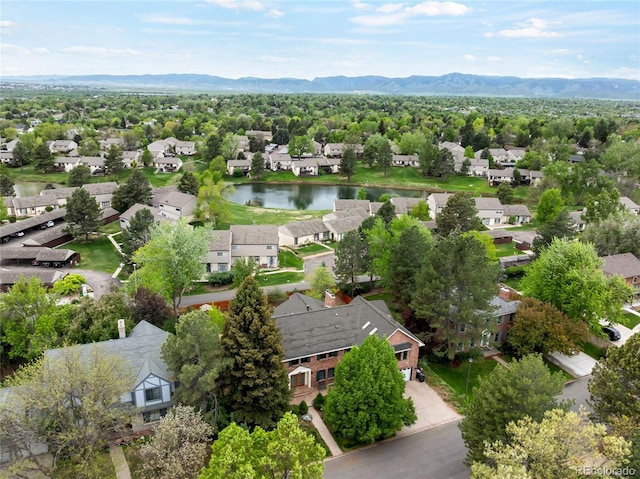 aerial view of residential area featuring a water and mountain view