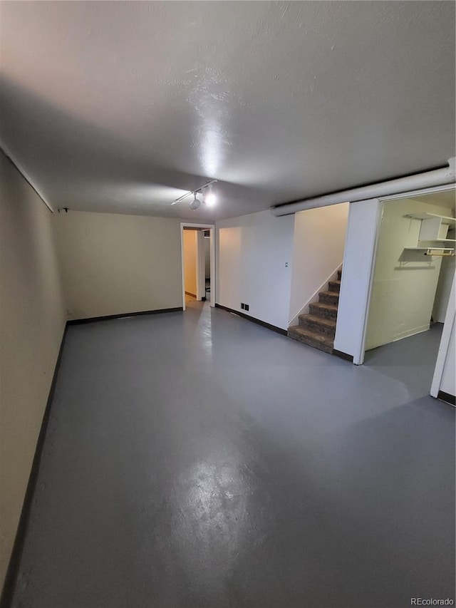 empty room featuring a textured ceiling and concrete floors