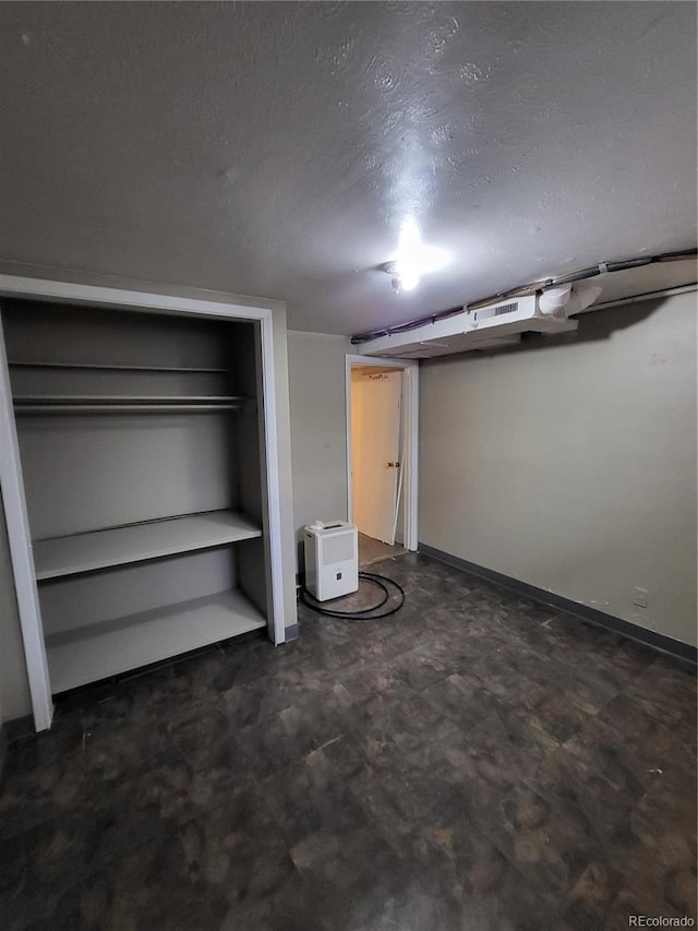 interior space featuring a closet and a textured ceiling