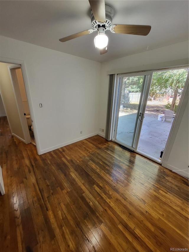 empty room featuring ceiling fan and dark hardwood / wood-style flooring