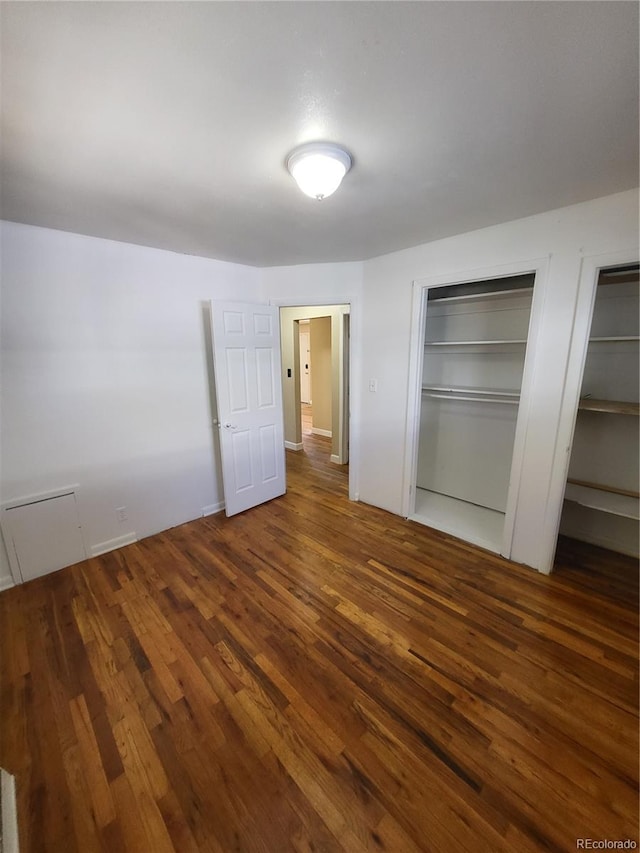 unfurnished bedroom featuring dark wood-type flooring