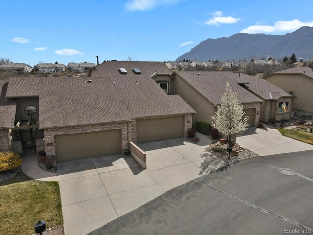 2866 Tenderfoot Hill St, Colorado Springs, CO 80906 - exterior space featuring a shingled roof, a residential view, driveway, brick siding, and a garage