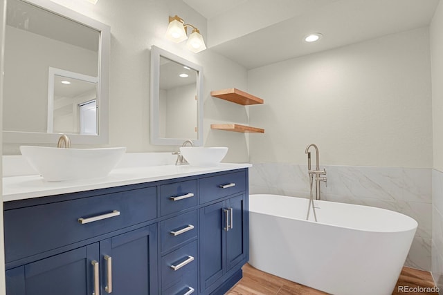 2866 Tenderfoot Hill St, Colorado Springs, CO 80906 - bathroom with tile walls, a soaking tub, a sink, and double vanity