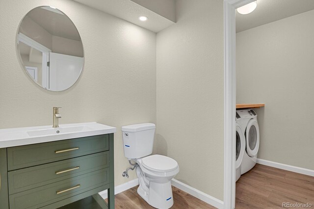 2866 Tenderfoot Hill St, Colorado Springs, CO 80906 - bathroom with toilet, baseboards, separate washer and dryer, wood finished floors, and vanity