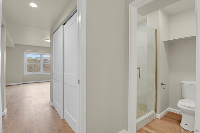 2866 Tenderfoot Hill St, Colorado Springs, CO 80906 - bathroom with wood finished floors, baseboards, a shower stall, and toilet