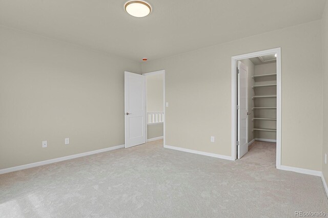 2866 Tenderfoot Hill St, Colorado Springs, CO 80906 - unfurnished bedroom with baseboards, a spacious closet, and light colored carpet