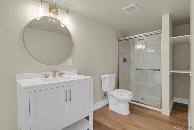 2866 Tenderfoot Hill St, Colorado Springs, CO 80906 - bathroom featuring toilet, a stall shower, visible vents, wood finished floors, and vanity