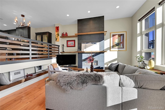 living room featuring a notable chandelier and wood-type flooring