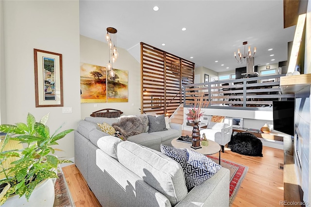 living room featuring a notable chandelier and light hardwood / wood-style floors